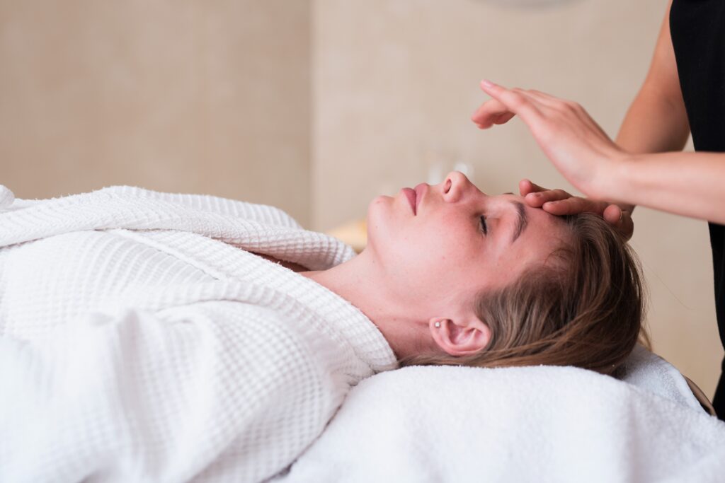 close up relaxed woman getting facial treatment 1